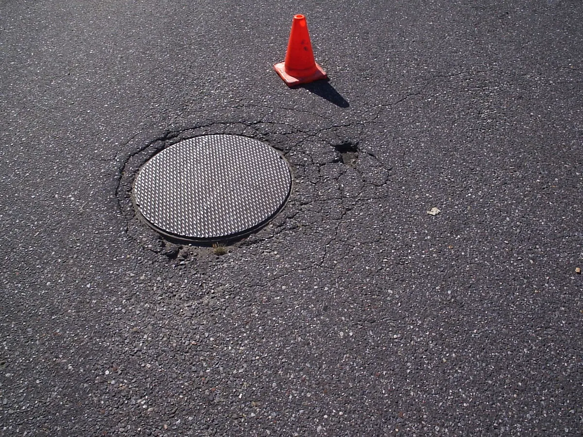 Manhole surround before repair